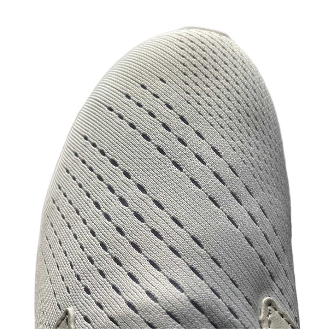 Close-up of a textured gray shoe sole with a white background