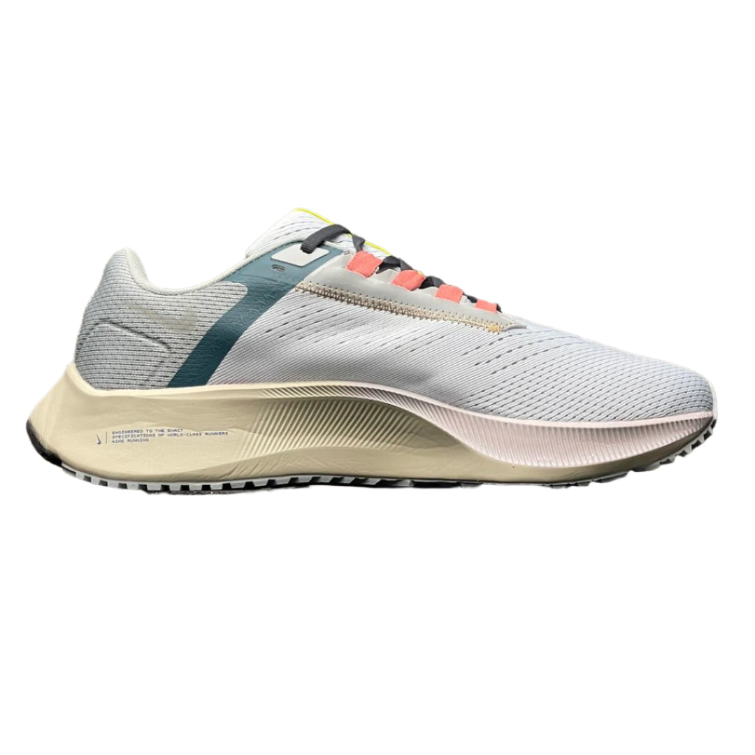 White running shoe with colorful accents on a textured surface