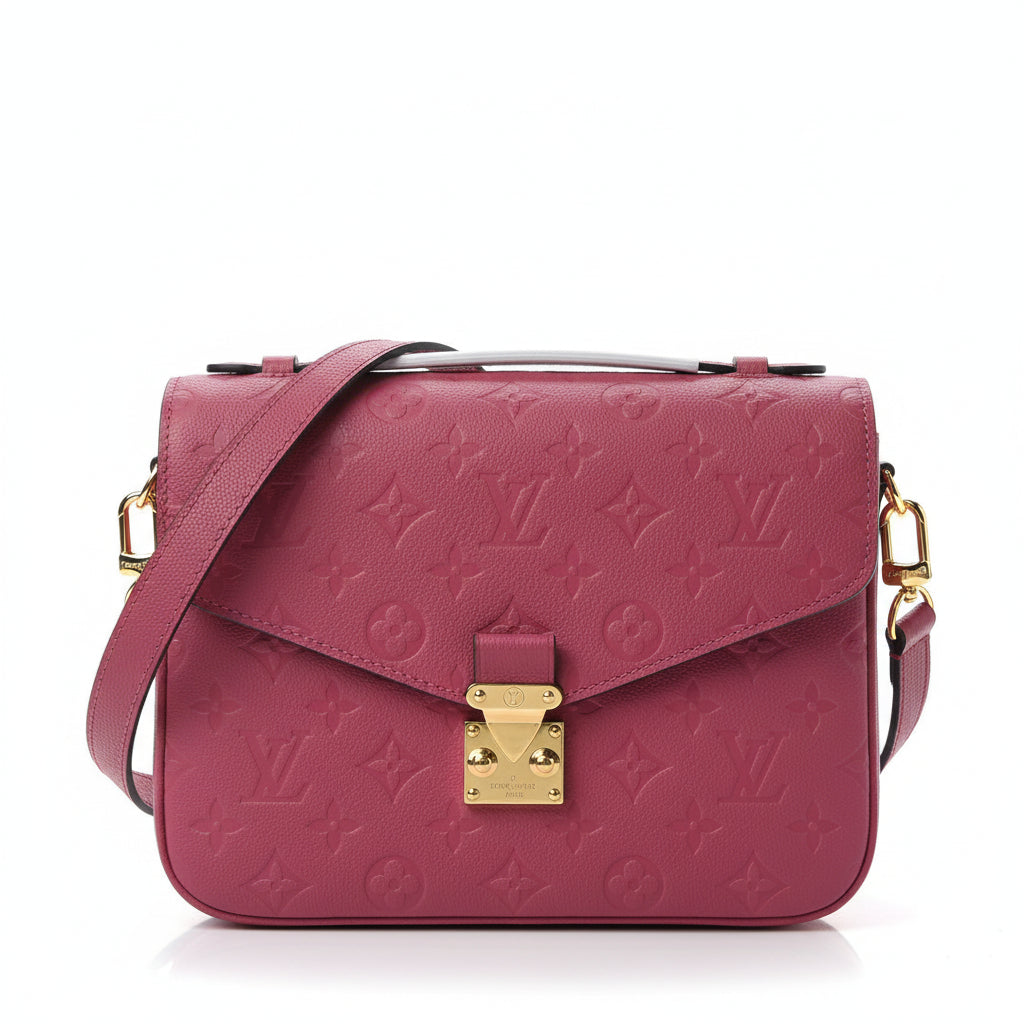Pink handbag with gold accents on a white background