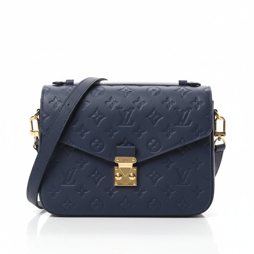 Navy blue handbag with gold hardware on a white background
